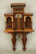 A 20th century bone inlaid hardwood, probably from Rajasthan, wall hanging shelf unit with central