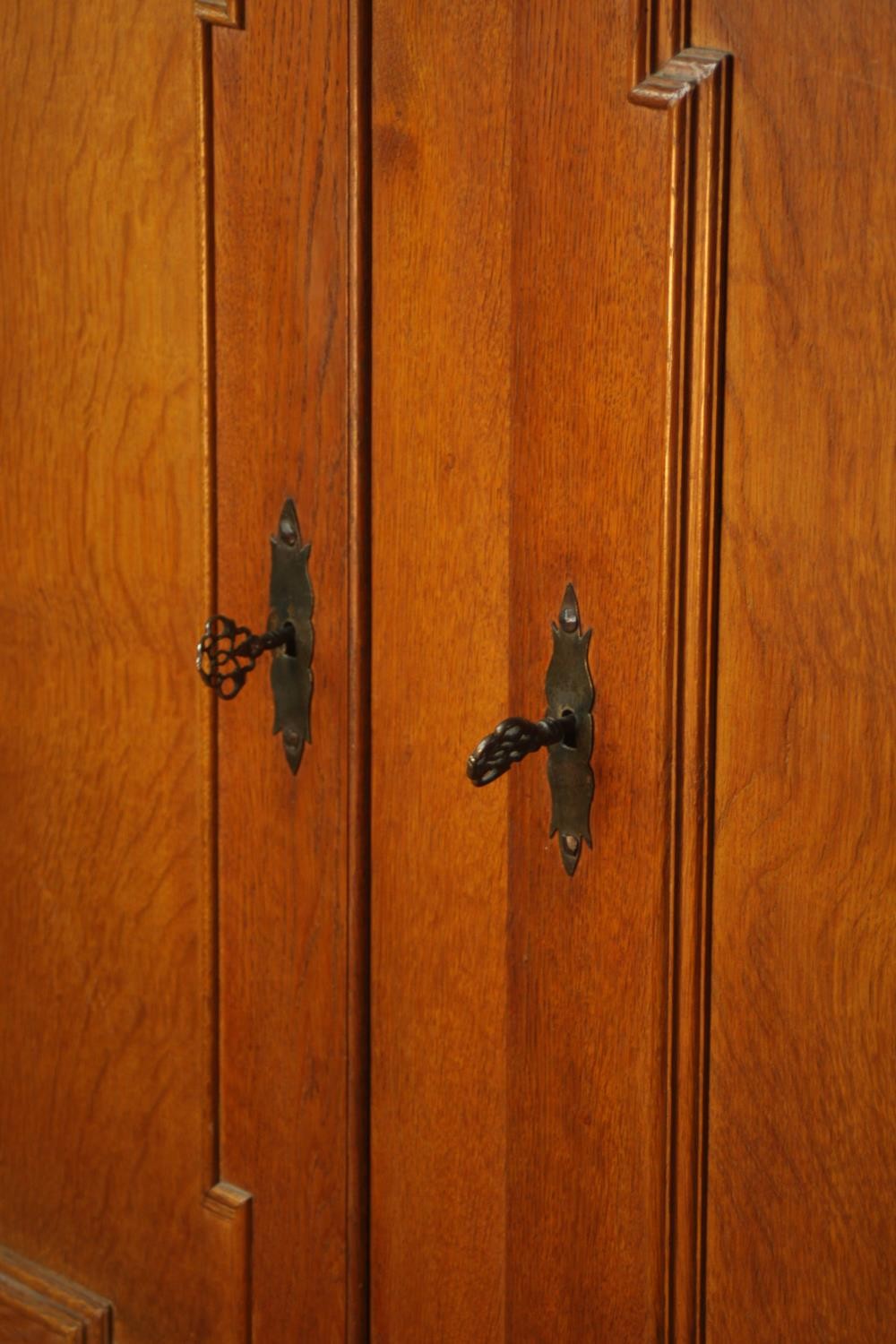 A late 19th century oak two door cupboard with two drawers below, raised on heavily carved - Image 6 of 10