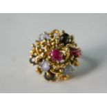 A 14 carat yellow gold and ruby and star sapphire abstract form dress ring. The ring set three