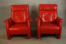 A pair of contemporary red leather armchairs raised on capped metal feet. H.100 W.85 D.90cm. (each)