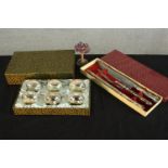 A boxed set of silver plated ash trays, a boxed silver plated floral design carving set and a