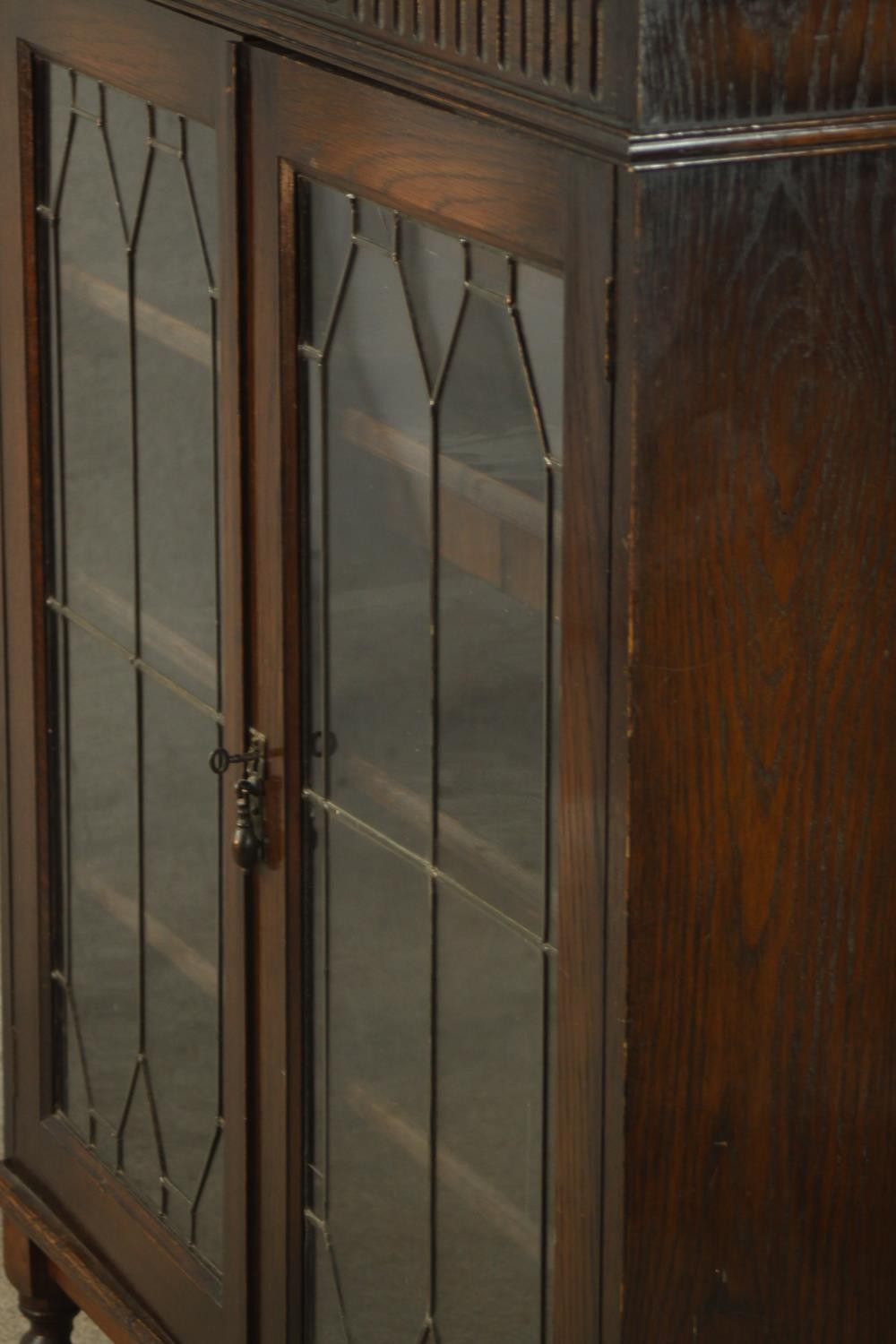 An early 20th century carved oak twin door leaded glass display cabinet, raised on turned supports - Image 7 of 9