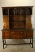 A 19th century oak dresser, the plate rack with twin cupboard doors, above two drawers and two