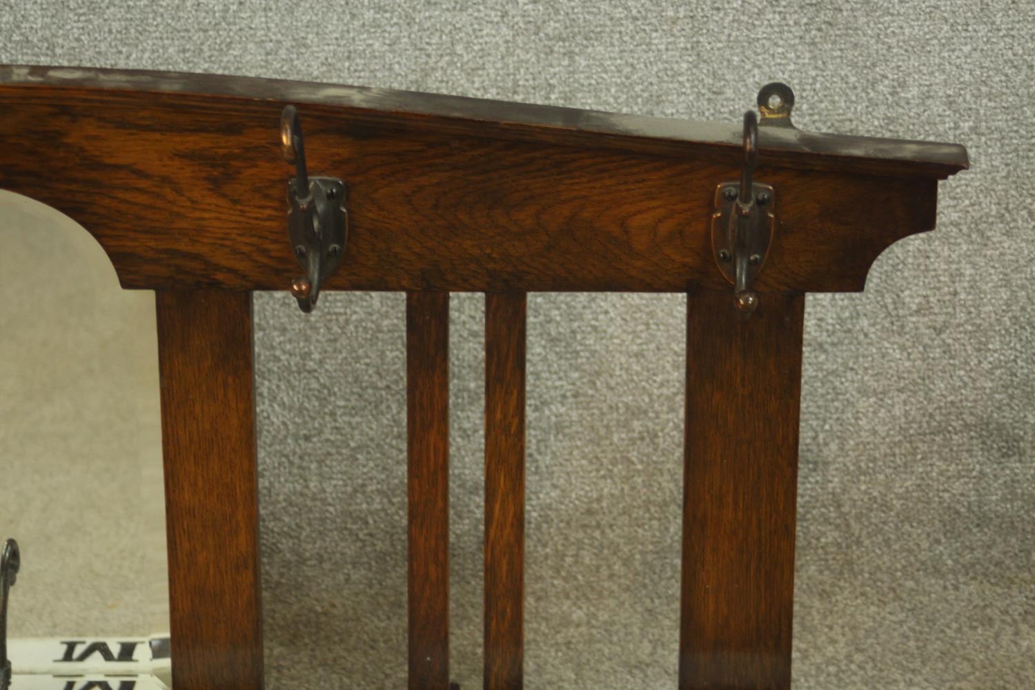 An early 20th century stained oak wall hanging mirror/coat stand. H.47 W.107 D.12cm. - Image 3 of 8