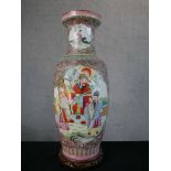 A Chinese porcelain baluster shaped vase decorated with panels of figures in a garden within