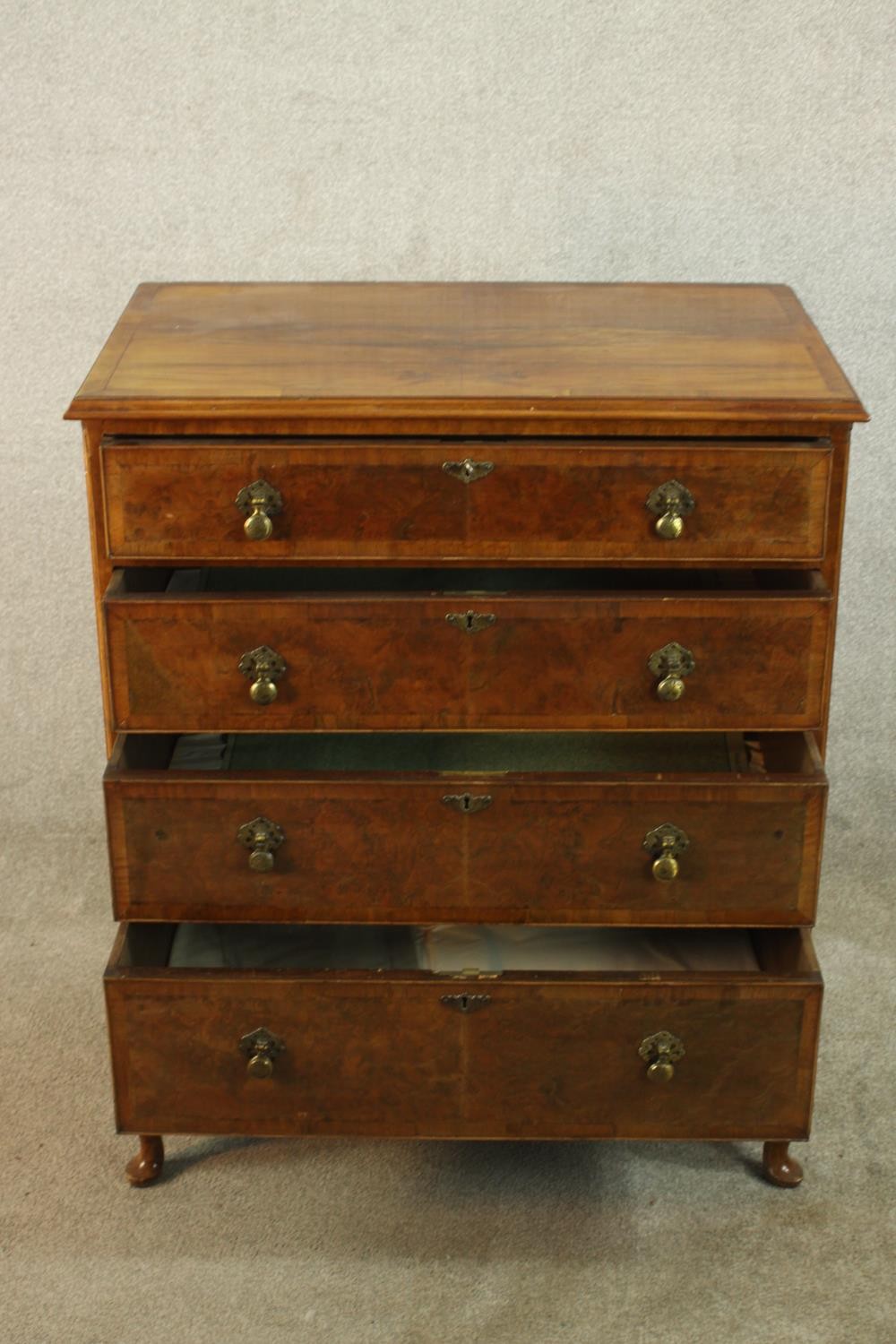 A 20th century walnut veneered chest of four graduating drawers, with brass swing handles, raised on - Image 5 of 9