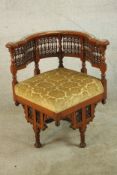 In the style of Carlo Bugatti, a mid 20th century Moorish style hardwood corner chair, with drop