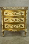 A 20th century painted Florentine style serpentine fronted chest of three graduating drawers, raised