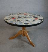 A 20th century circular table, with painted mosaic effect top raised on turned central pine column