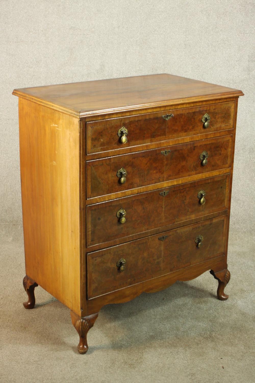 A 20th century walnut veneered chest of four graduating drawers, with brass swing handles, raised on - Image 3 of 9