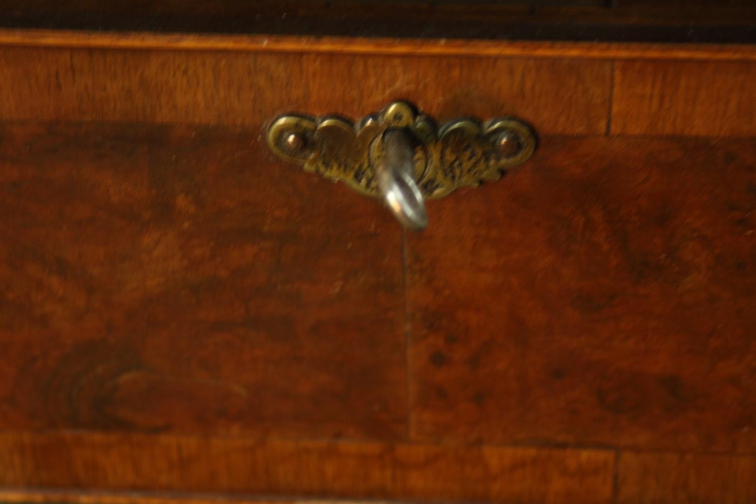 A 20th century walnut veneered chest of four graduating drawers, with brass swing handles, raised on - Image 8 of 9