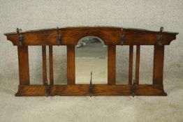 An early 20th century stained oak wall hanging mirror/coat stand. H.47 W.107 D.12cm.