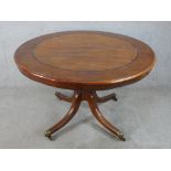 A 19th/early 20th century inlaid mahogany circular tilt topped table, raised on four splayed