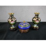 A pair of 20th century Chinese cloisonne baluster vases decorated with flowers, raised on pierced