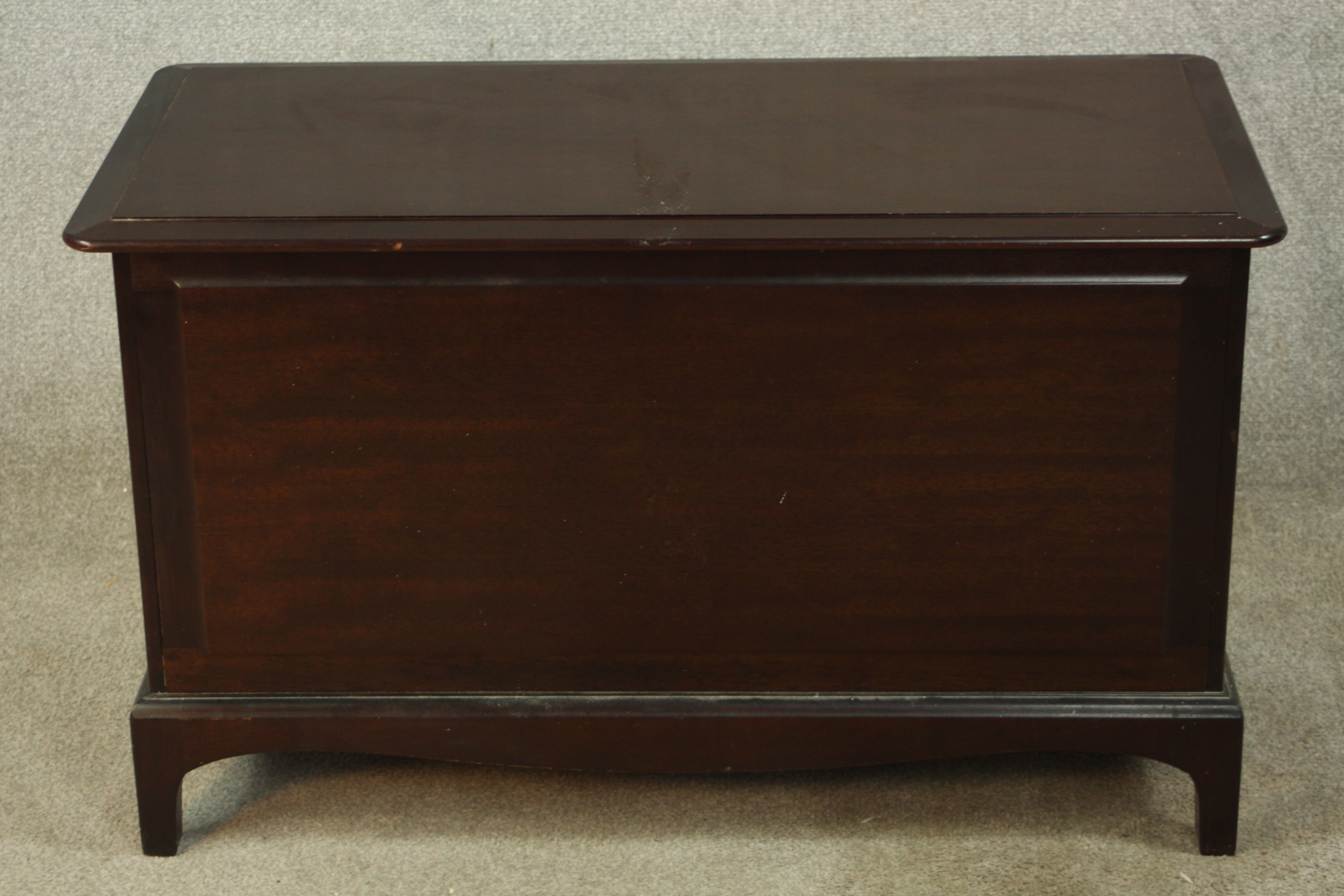 A 20th century mahogany Stag Minstrel blanket box, raised on shaped bracket feet. H.57 W.96 D.48cm.