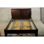 A contemporary stained mahogany double bed. H.101 W.145 D.210cm.