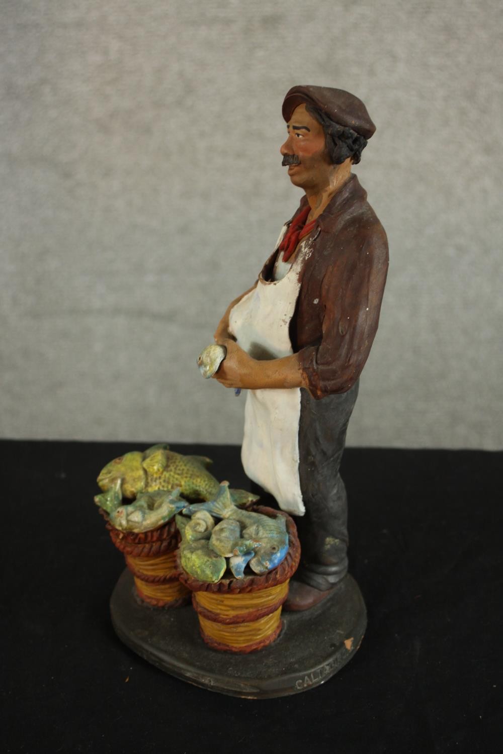 A 20th century Russian painted pottery figure of a a fishmonger, impressed marks. H.25 W.13 D.11cm. - Image 6 of 6