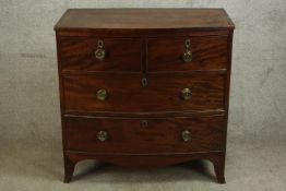 A 19th century mahogany bow fronted chest of two short over two long drawers, raised on shaped