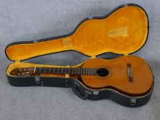 A mid/late 20th century Spanish guitar, with carrying case. H.104 W.42 D.14cm.