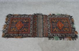 A 20th century blue ground two section carpet bag with all over geometric pattern. W.117 D.51cm