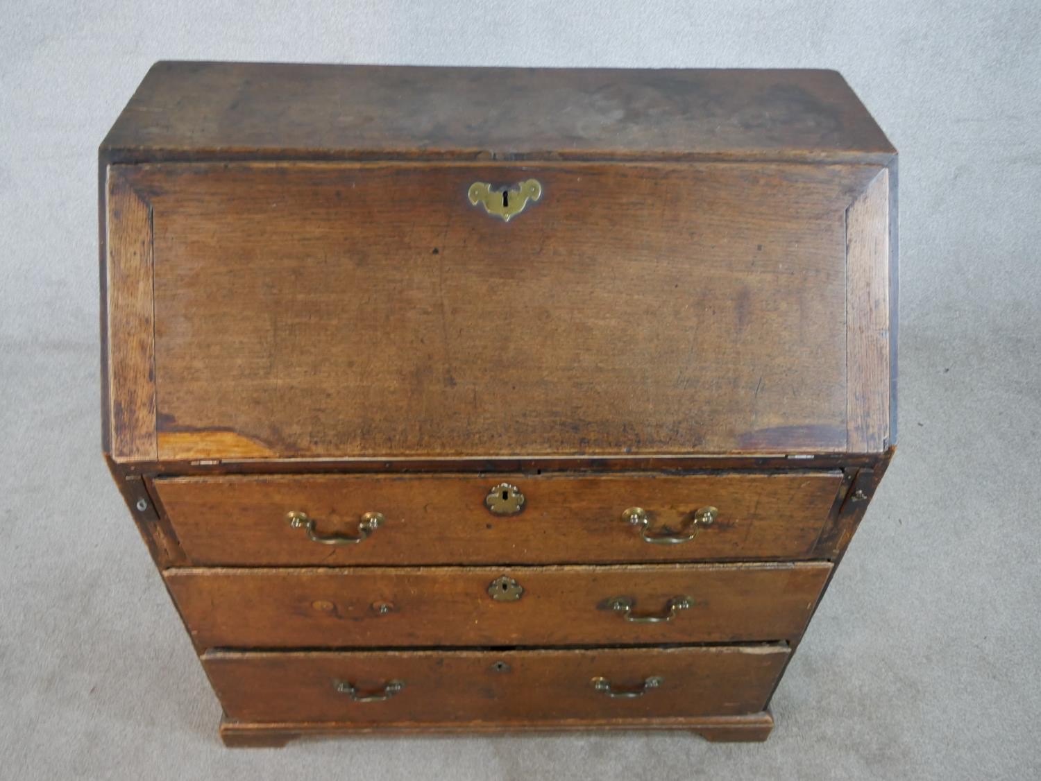 A 19th century oak fall front bureau, the fall front opening to reveal fitted interior, above - Image 2 of 9