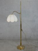 A 20th century brass adjustable standard lamp, raised on circular foot. H.152 W.45cm