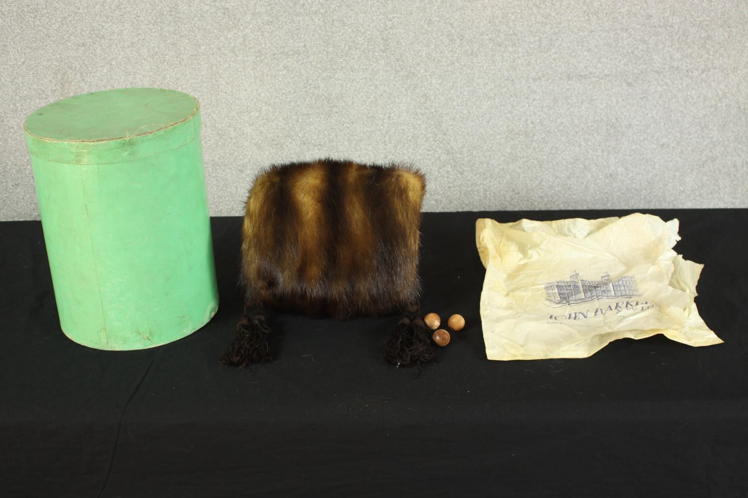 An early 20th century John Barker and Co boxed and packaged mink fur hand muff with silk tassel