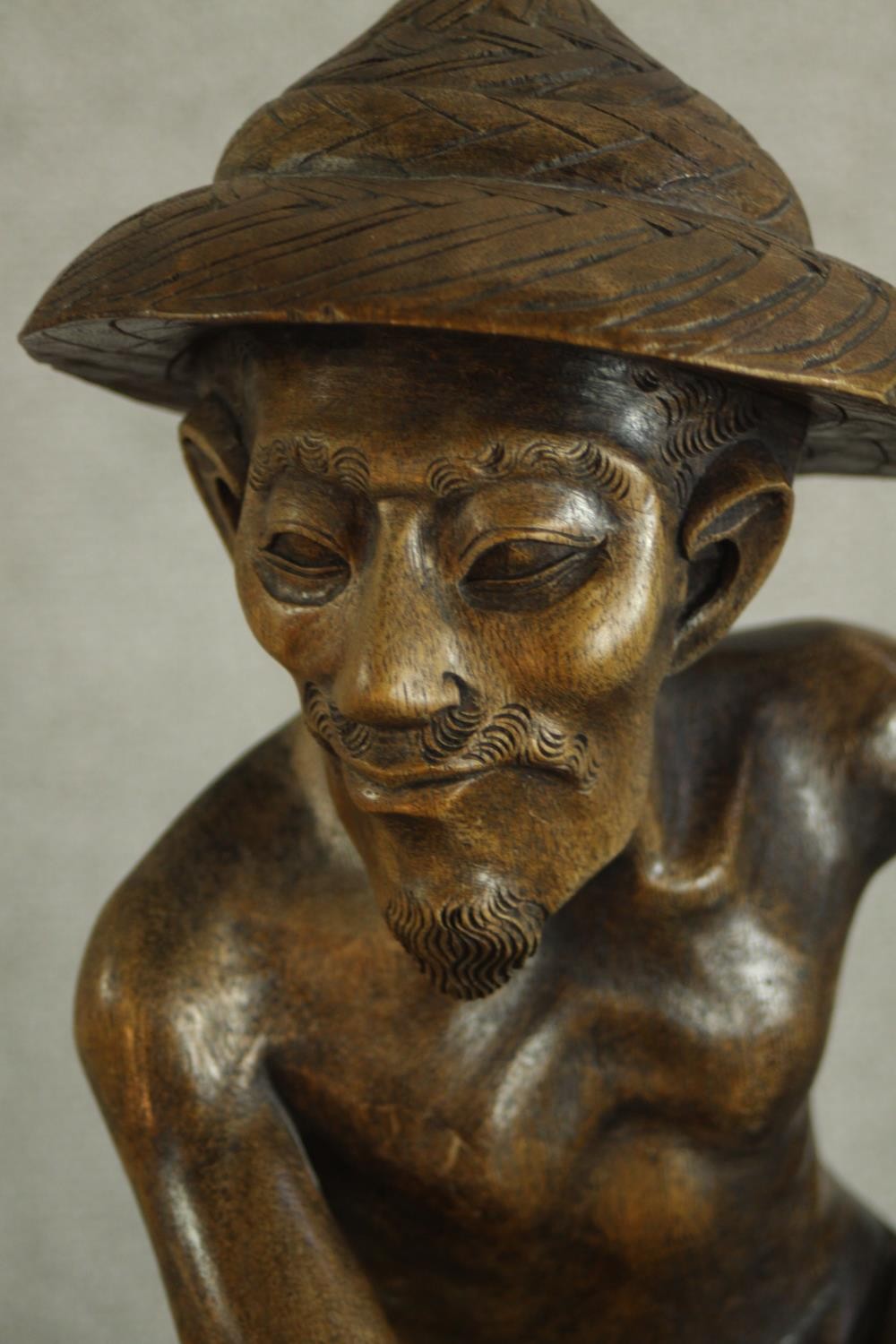 An early 20th century carved Chinese hardwood fisherman, raised on naturalistic base. H.63 W.25 D. - Image 5 of 6
