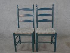 A pair of 20th century painted Shaker style ladder back chairs, raised on turned supports and