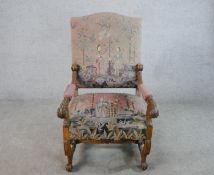 A 19th century carved walnut framed open arm chair, upholstered in Medieval style handmade