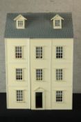 A late 20th century painted dolls house, opening to reveal various decorated rooms. H.85 W.58 D.