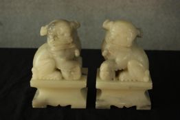 A pair of 20th century Chinese soapstone carved Dogs of Fo bookends, with incised detail decoration,