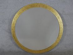 A contemporary gilt framed circular wall mirror with three tier petal style decoration. Dia.
