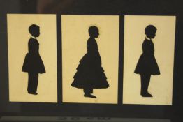 A 19th century set of three framed silhouettes of children on paper. H.24 W.30cm.