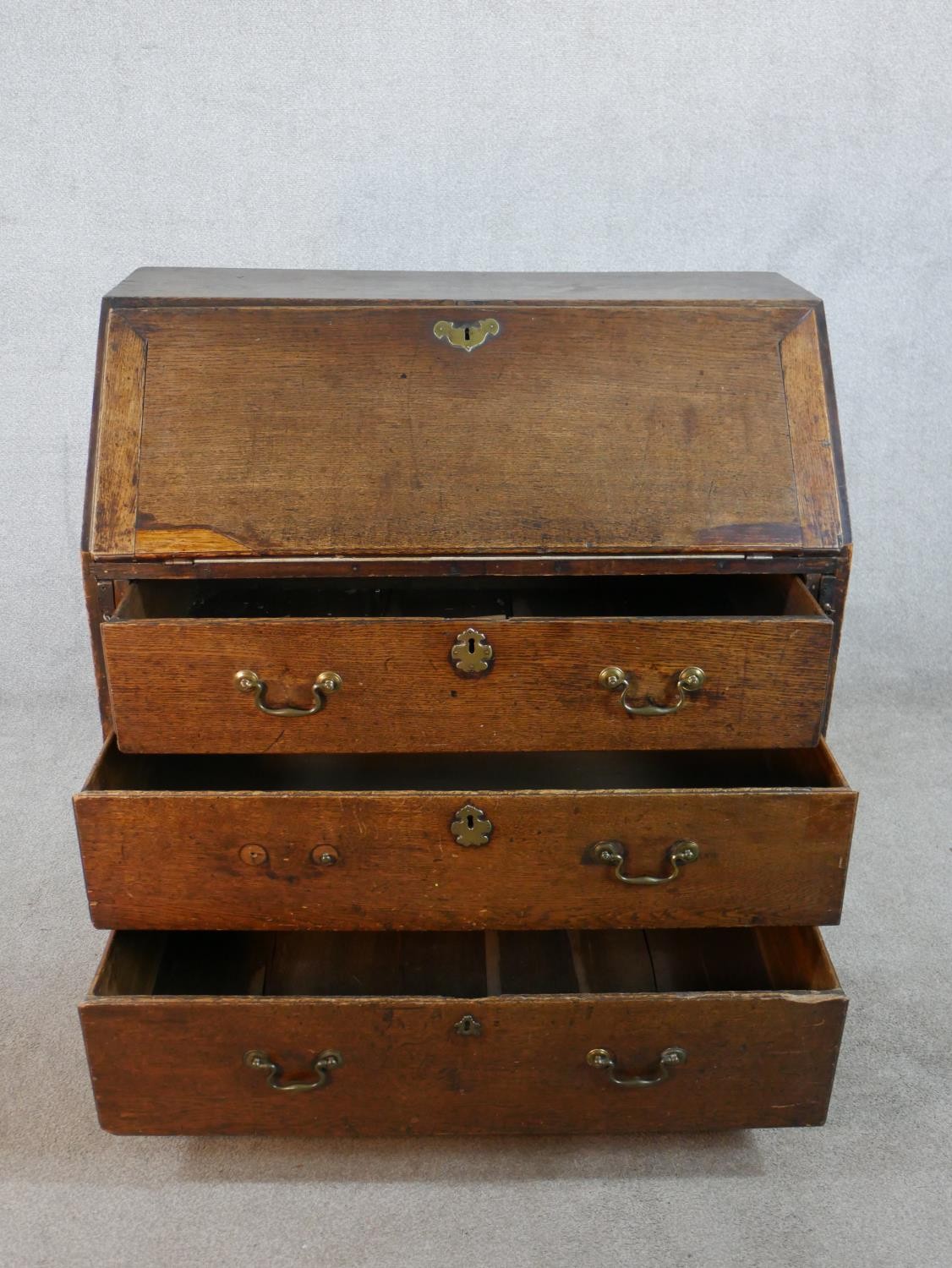 A 19th century oak fall front bureau, the fall front opening to reveal fitted interior, above - Image 3 of 9