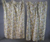 A pair of 20th century cream ground curtains decorated with sprays of flowers. H.140 W.76cm