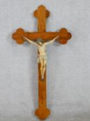 A late 19th/early 20th century oak form crucifix, mounted with a painted carved figure of Jesus