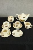 A mid 20th century Kenyan porcelain part tea set to include cups, saucers, milk jug, lidded sugar