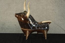A mid 20th century glazed and painted ceramic modernist bull, signed and dated '56 to base. H.35 W.