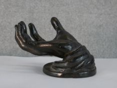 After the Antique, a cast bronze hand stand. H.12 W.17 D.12cm.