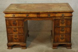 A 18th century walnut veneered twin pedestal desk with two central drawers, raised on two