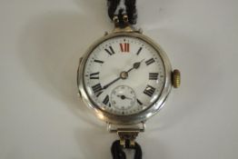 An Art Deco silver watch with white enamel dial with Roman numerals and stop watch dial. Hallmarked: