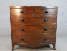 A 19th century mahogany bow fronted chest of two short over three long drawers, raised on shaped