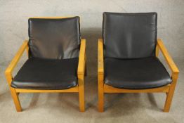A mid 20th century teak framed open arm lounge chairs, with loose seats and backs. H.68 W.64 D.80cm.