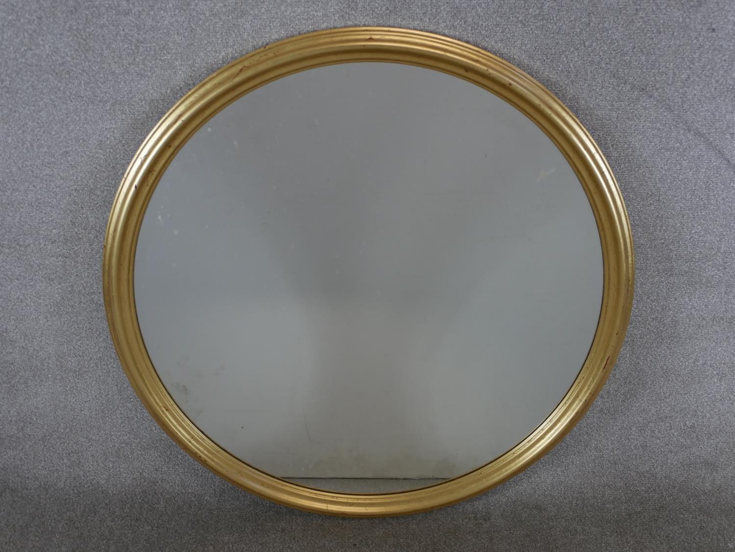 A late 20th century gilt painted circular wall mirror. Dia.91cm.