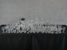 A large of cut and moulded drinking glasses, together with a silver plated mounted cut glass