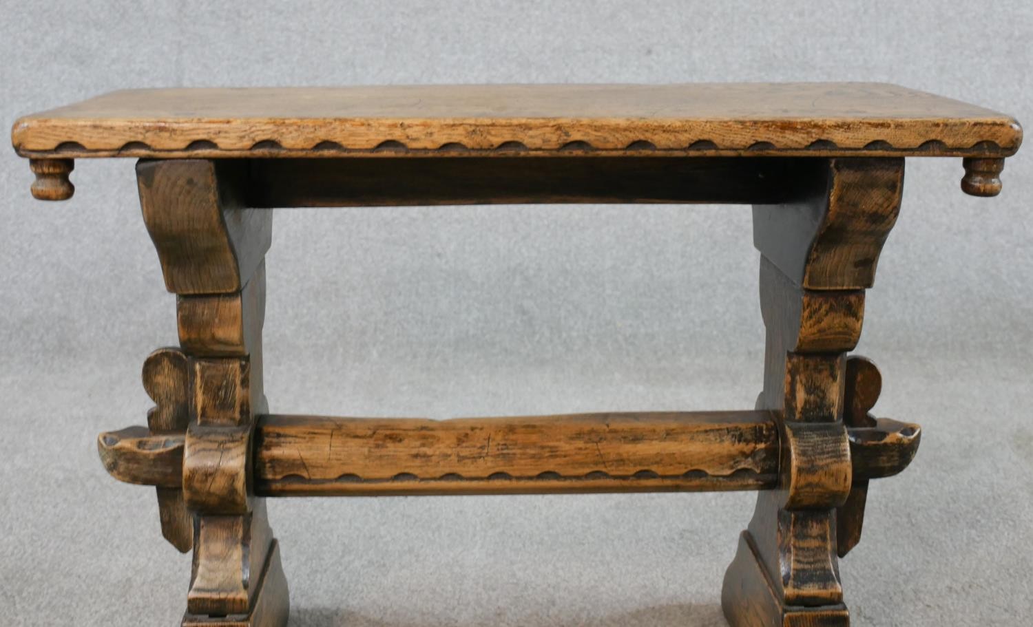 A late 19th/early 20th century stained oak stool, raised on carved trestle supports with block feet. - Image 3 of 5