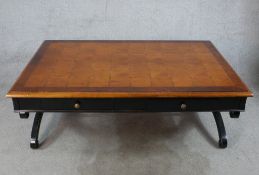 A contemporary marquetry effect topped and four drawer lounge table with brass knob handles,