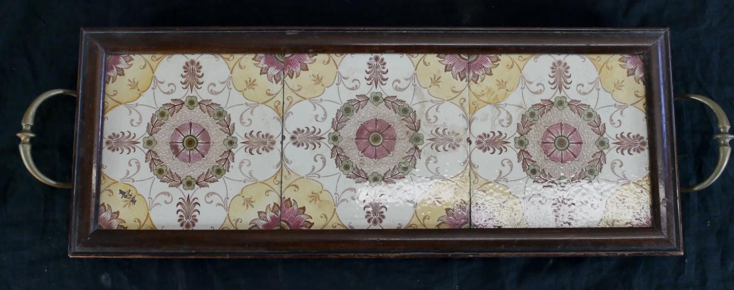 A late 19th century mahogany and brass twin handled tray, inset with three floral decorated square