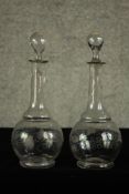 A pair of early 20th century glass decanters and stoppers each etched with grape and vine